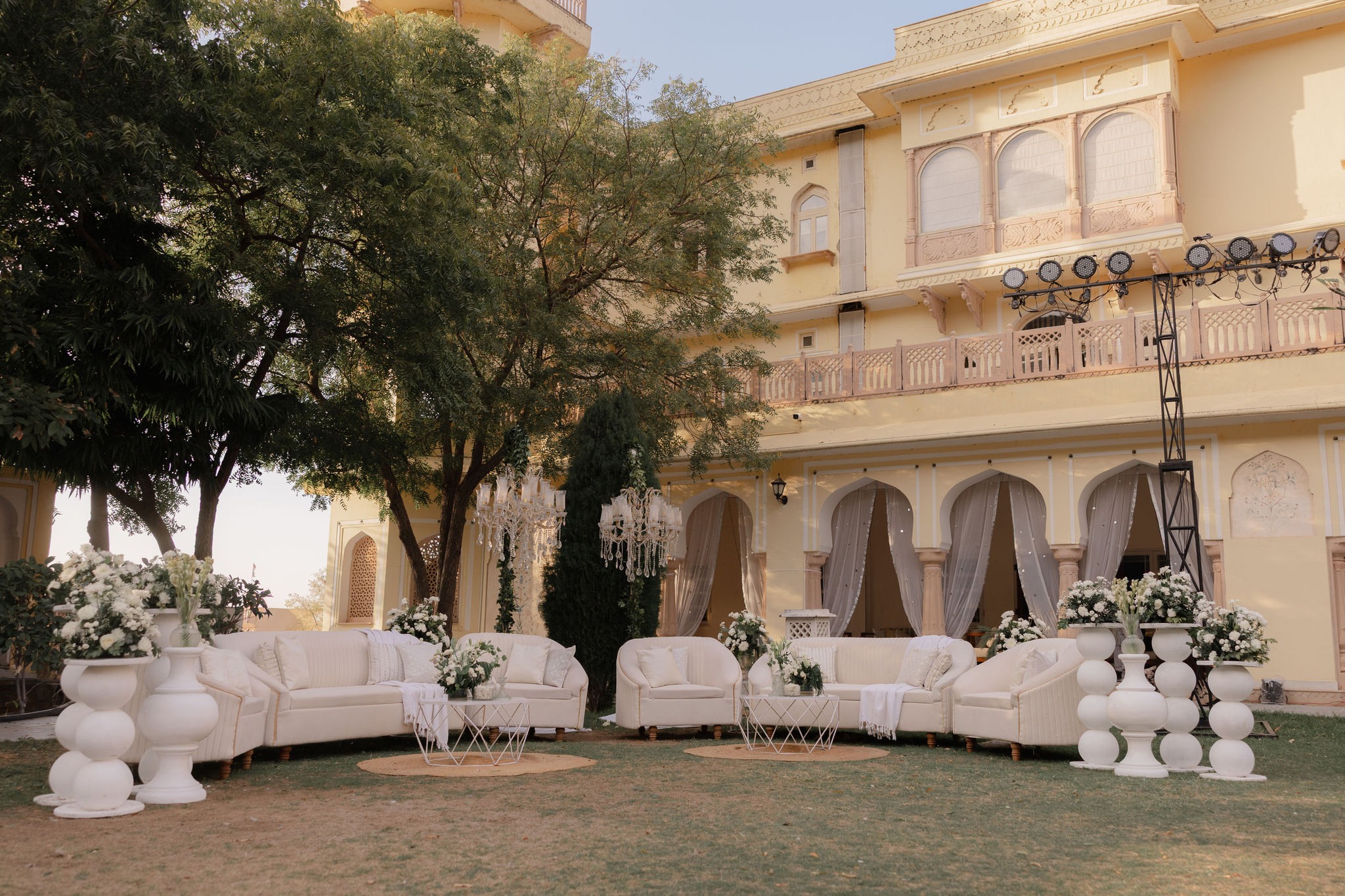 White lounge seating on the palace lawn — Anupama & Abhinav, Mundota Palace, Jaipur
