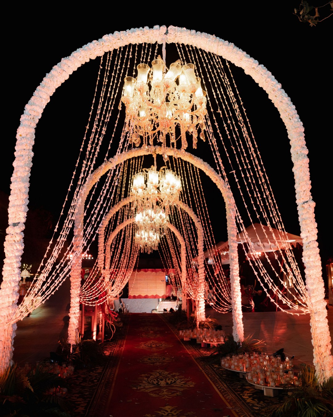 Illuminated chandelier arch for the sangeet night — Anupama & Abhinav, Mundota Palace, Jaipur