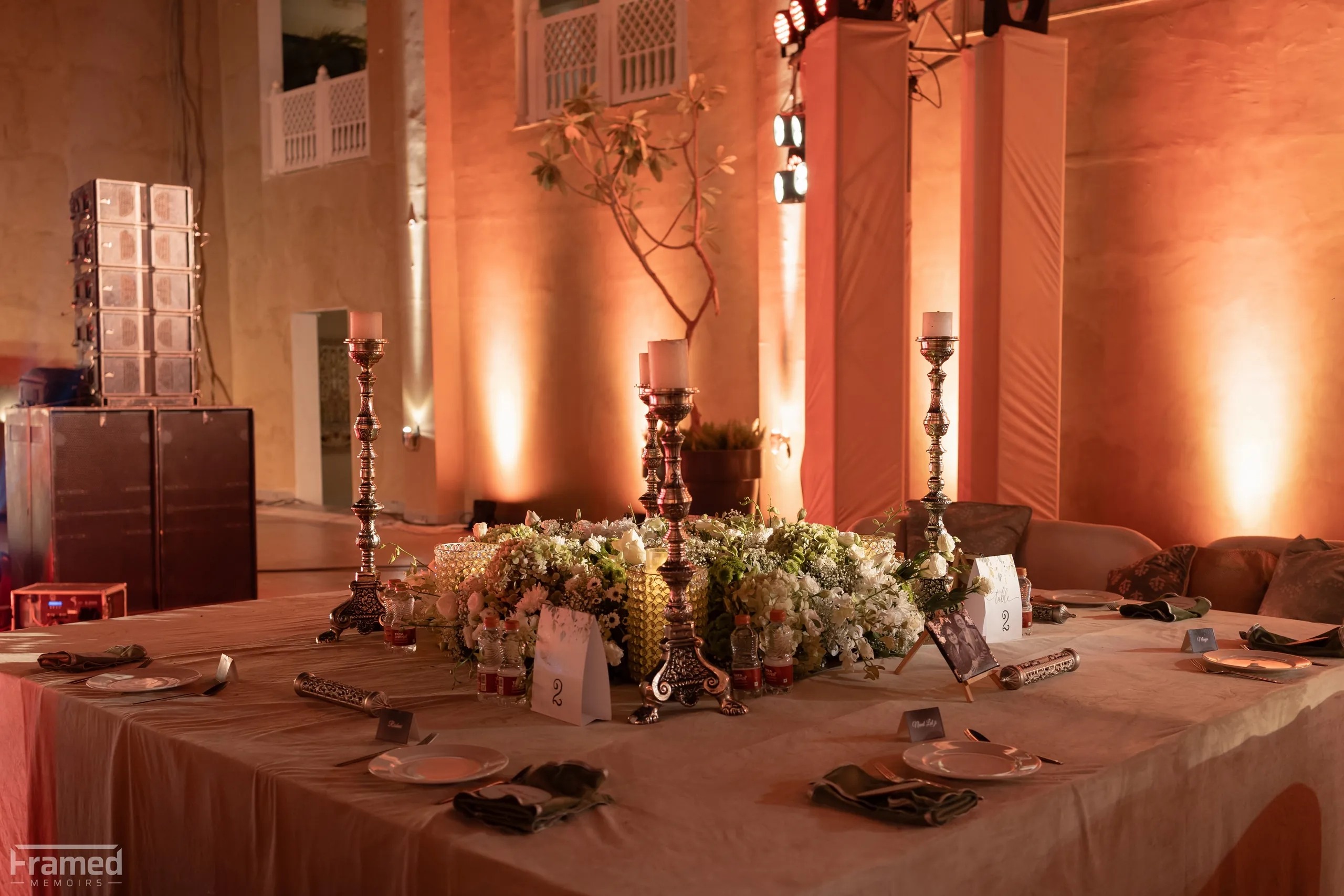 A candle-lit dinner table under warm lighting
