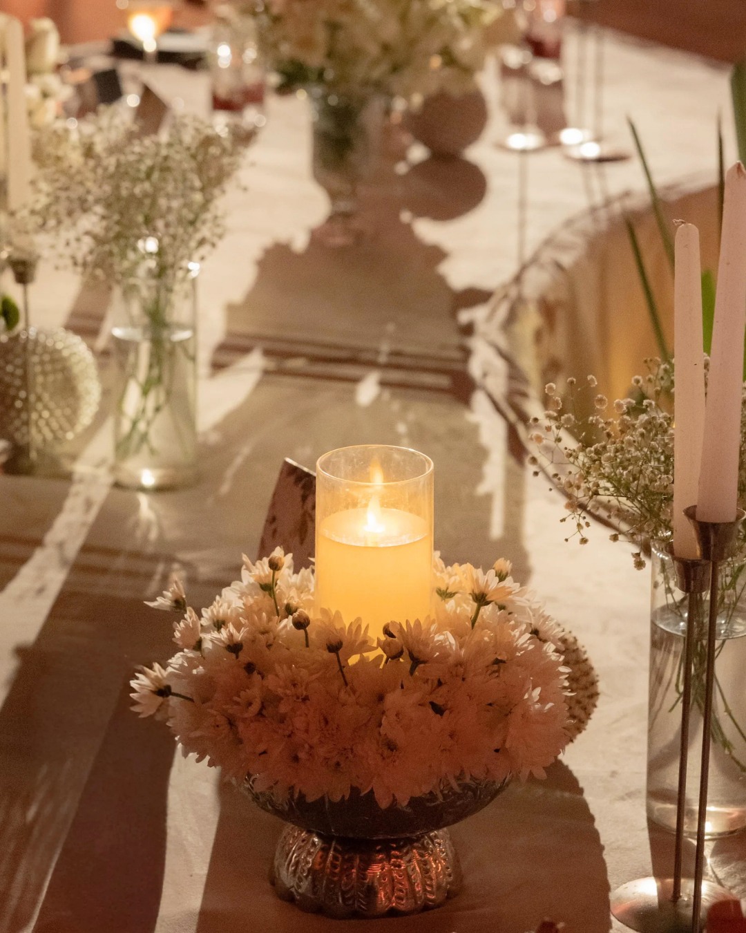 Candles and white florals at the welcome dinner — Devanshi & Rohan, Taj Lalit Bagh, Udaipur