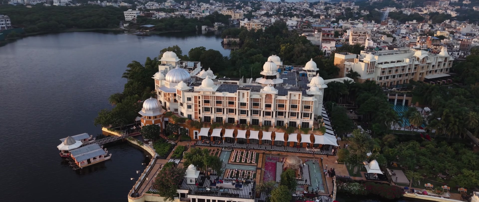 Aerial film of The Leela Palace on Lake Pichola at golden hour